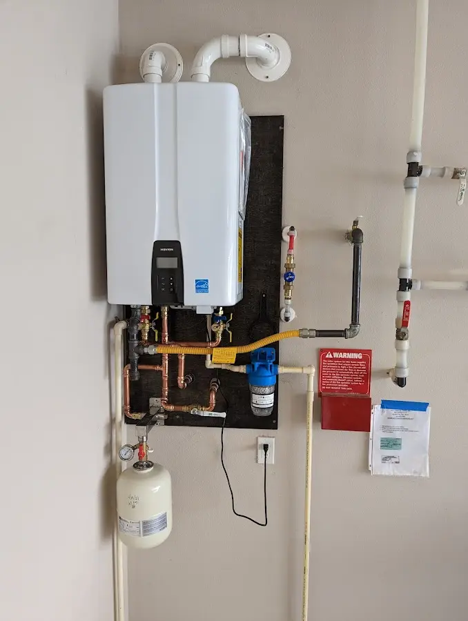 Professional plumber installing copper piping in a St. Joseph home